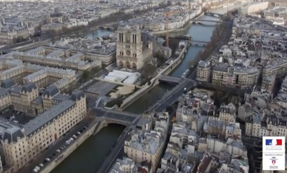 This image taken from drone video on March 19, 2020 and made available by the Prefecture de Police de Paris, shows the empty streets of Paris surrounding the Notre Dame Cathedral during lockdown to combat the spread of the new coronavirus. The footage shows landmarks and tourist hotspots in Paris completely empty, with only a few cars on the streets. For most people, the new coronavirus causes mild or moderate symptoms, such as fever and cough that clear up in two to three weeks. (Prefecture de Police de Paris via AP)