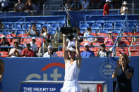 Liudmila Samsonova, of Russia, hoists the trophy after she won the final at the Citi Open tennis tournament against Kaia Kanepi, of Estonia, Sunday, Aug. 7, 2022, in Washington. (AP Photo/Nick Wass)