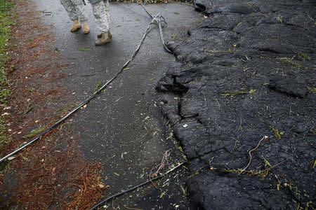 Hawaii National Guardsmen stand near the lava flow, in Leilani Estates near Pahoa, Hawaii, U.S., May 29, 2018. REUTERS/Marco Garcia