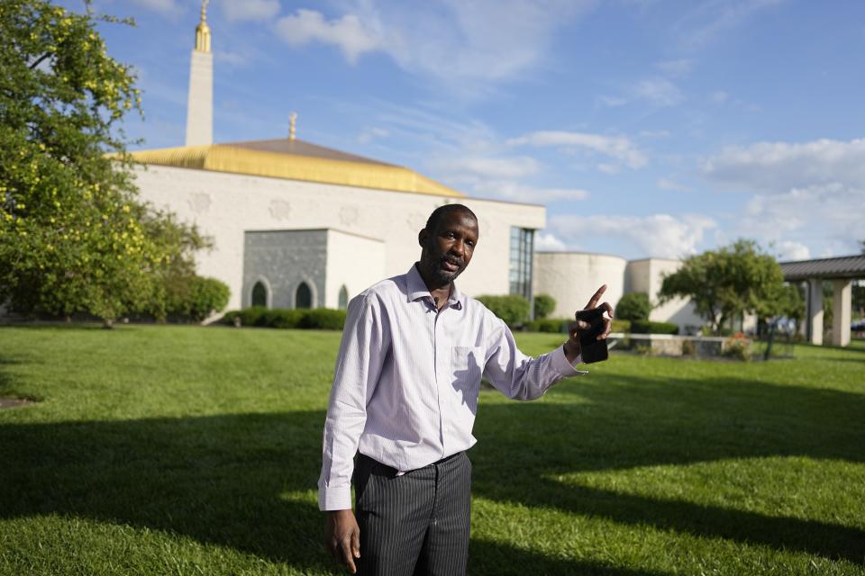 Oumar Ball speaks outside of the Islamic Center, Friday, July 21, 2023, in Cincinnati. Ball arrived in Cincinnati in 1997 and recently opened his home more than a dozen other new migrants also from Mauritania. A new surge in migration from Mauritania to the U.S. was made possible by the discovery this year of a new route through Nicaragua, where relaxed entry requirements allow Mauritanians and a handful of other foreign nationals to purchase a low-cost visa without proof of onward travel. (AP Photo/Darron Cummings)