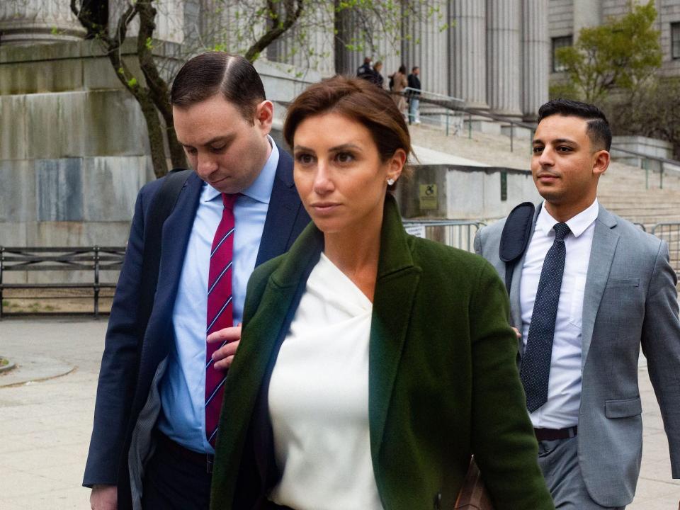 Lawyer Alina Habba, center, with two men, leaving Manhattan Supreme Court on April 25, 2022,