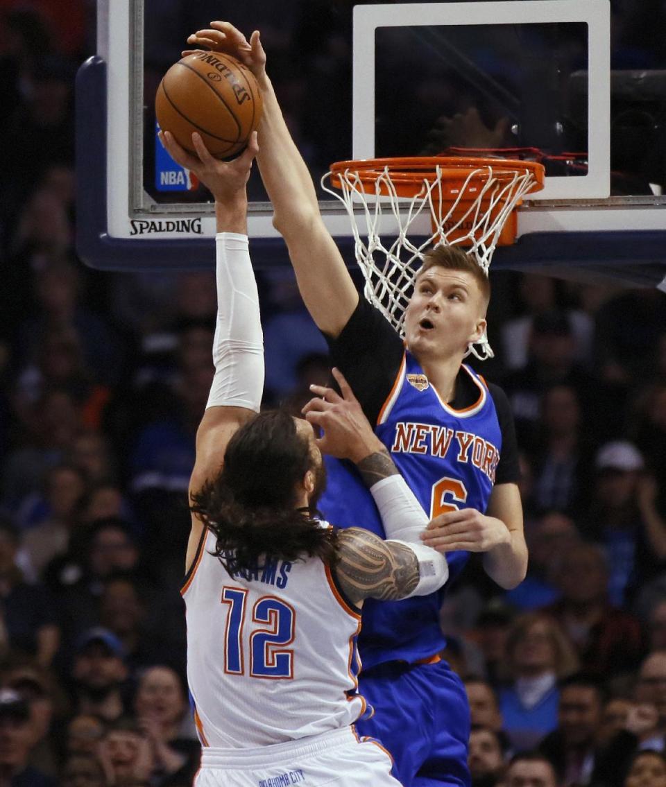 New York Knicks forward Kristaps Porzingis (6) blocks a shot by Oklahoma City Thunder's Steven Adams during the first quarter of an NBA basketball game in Oklahoma City, Wednesday, Feb. 15, 2017. (AP Photo/Sue Ogrocki)