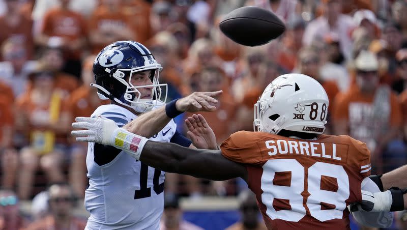 BYU quarterback Kedon Slovis (10) throws under pressure from Texas defensive end Barryn Sorrell (88) during the first half of an NCAA college football game in Austin, Texas, Saturday, Oct. 28, 2023.