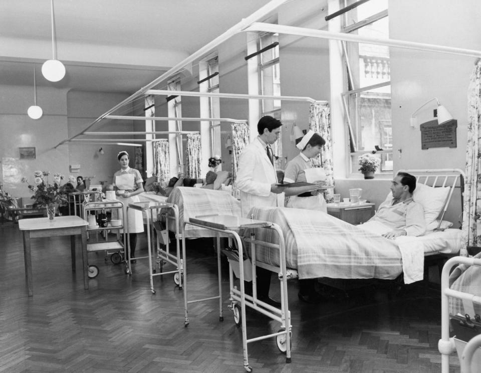 A doctor on his morning rounds in the men's surgical ward at St. Bartholomew's Hospital: A doctor on his morning rounds in the men's surgical ward at St. Bartholomew's Hospital (Getty Images)