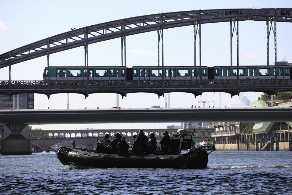 FILE - Members of the elite police squad RAID sit in an inflatable boat during an operational test for the Paris 2024 Olympic Games opening ceremony, Monday, July 17, 2023 in Paris. Paris officials Wednesday Nov.29, 2023 urged residents of the French capital to stay and enjoy the Olympic festivities next summer, as they unveiled security measures that will impact daily life during the July 26-Aug 11 Summer Games. (AP Photo/Aurelien Morissard, File)