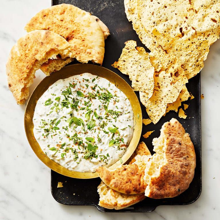 <p>This creamy cucumber yogurt dip can be served with bread and chips. Plus, it makes a great topping for any spicy dishes you're serving at this year's Halloween party. </p><p>Get the <a href="https://www.goodhousekeeping.com/food-recipes/a38552934/raita-recipe/" rel="nofollow noopener" target="_blank" data-ylk="slk:Raita recipe;elm:context_link;itc:0;sec:content-canvas" class="link "><strong>Raita recipe</strong></a>. </p>