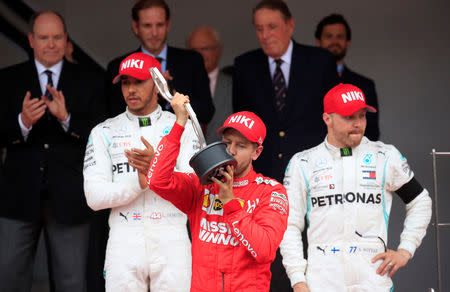 Formula One F1 - Monaco Grand Prix - Circuit de Monaco, Monte Carlo, Monaco - May 26, 2019 Ferrari's Sebastian Vettel celebrates second place in the Monaco Grand Prix with the race winner Mercedes' Lewis Hamilton and third place Mercedes' Valtteri Bottas REUTERS/Gonzalo Fuentes