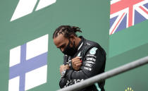 Mercedes driver Lewis Hamilton of Britain celebrates on the podium after winning the Formula One Grand Prix at the Spa-Francorchamps racetrack in Spa, Belgium, Sunday, Aug. 30, 2020. (Stephanie Lecocq, Pool via AP)