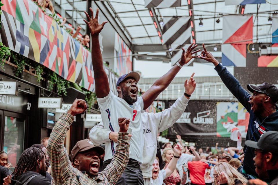 Stormzy celebrating England’s victory over Germany in the Euro 2020 round of 16 match at BOXPARK Croydon in south Londo (PA)