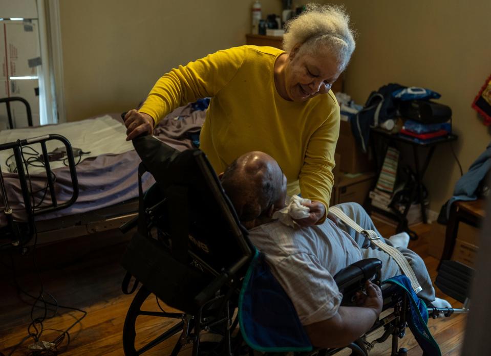 Debra Westbrook, of Detroit, finishes giving her son Marvin McQueen Jr. a haircut at their home in Detroit on Thursday, Feb. 10, 2022.