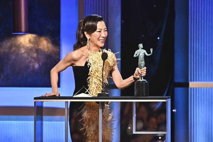 Michelle Yeoh at the podium holding an award