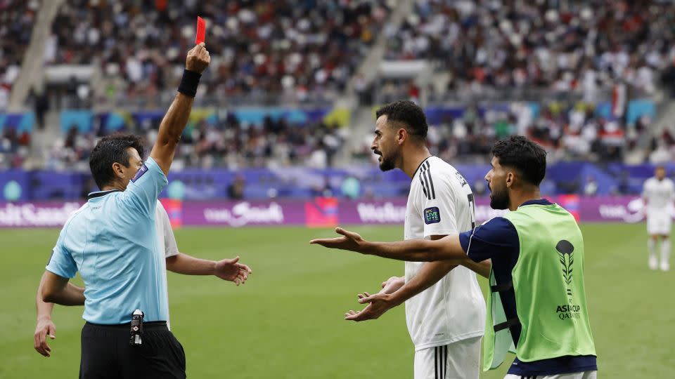 Hussein is shown a red card after his goal. - Thaier Al-Sudani/Reuters