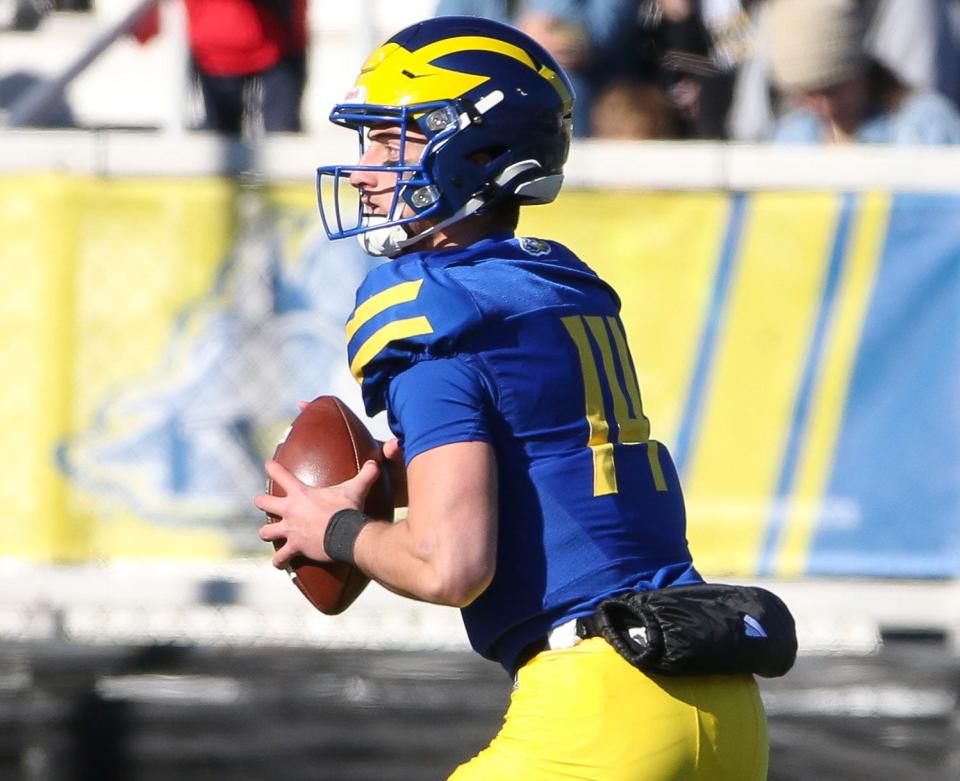 Delaware quarterback Ryan O'Connor throws back to quarterback Zach Marker on Delaware's first play for a thirty nine-yard gain on a double pass in the first quarter against Villanova at Delaware Stadium, Saturday, Nov. 18, 2023.
