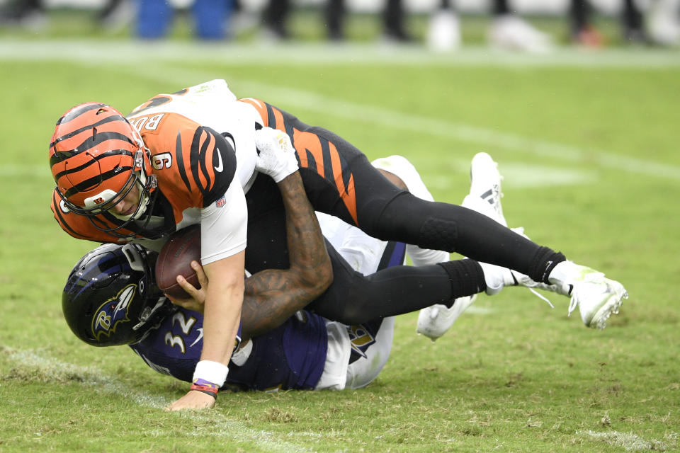 Baltimore Ravens linebacker Tyus Bowser, back, records a sack on Cincinnati Bengals quarterback Joe Burrow as he tries a pass during the first half of an NFL football game, Sunday, Oct. 11, 2020, in Baltimore. (AP Photo/Nick Wass)