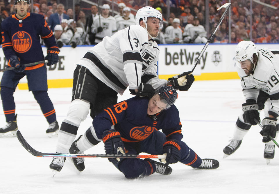 Los Angeles Kings' Matt Roy (3) checks Edmonton Oilers' Zach Hyman (18) during the second period of Game 1 of an NHL hockey Stanley Cup first-round playoff series, Monday, May 2, 2022 in Edmonton, Alberta. (Jason Franson/The Canadian Press via AP)