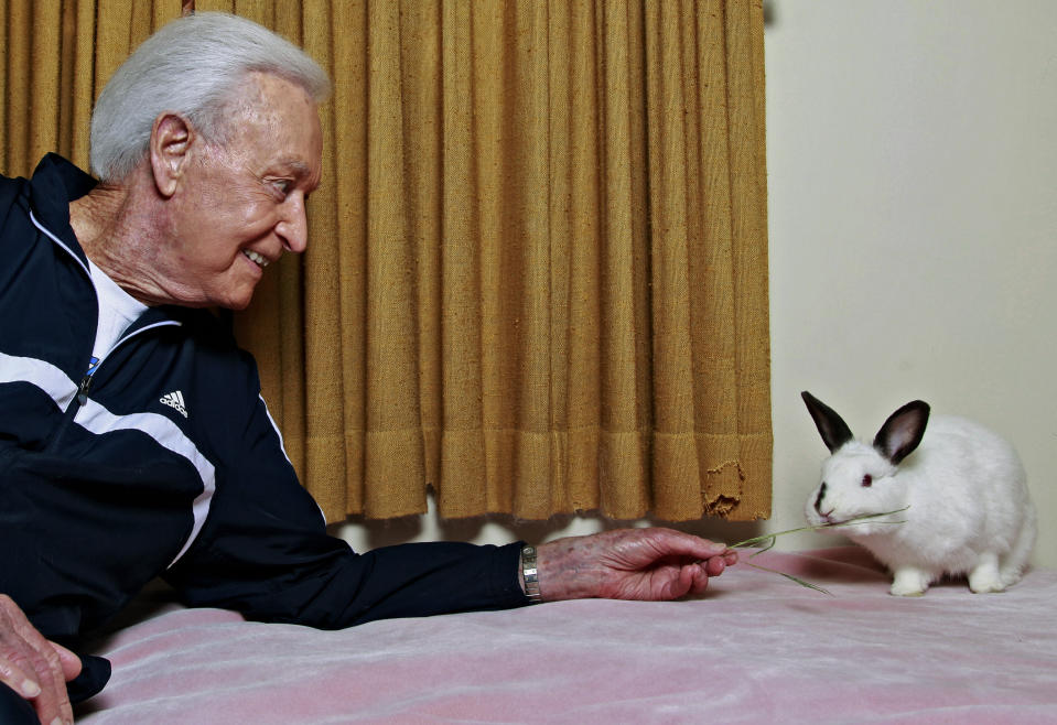 FILE - In this Tuesday, Dec. 13, 2011 photo, retired game show host Bob Barker, a longtime animal rights advocate, holds his 8-year-old rabbit Mr. Rabbit at his home in Los Angeles. (AP Photo/Damian Dovarganes, File)