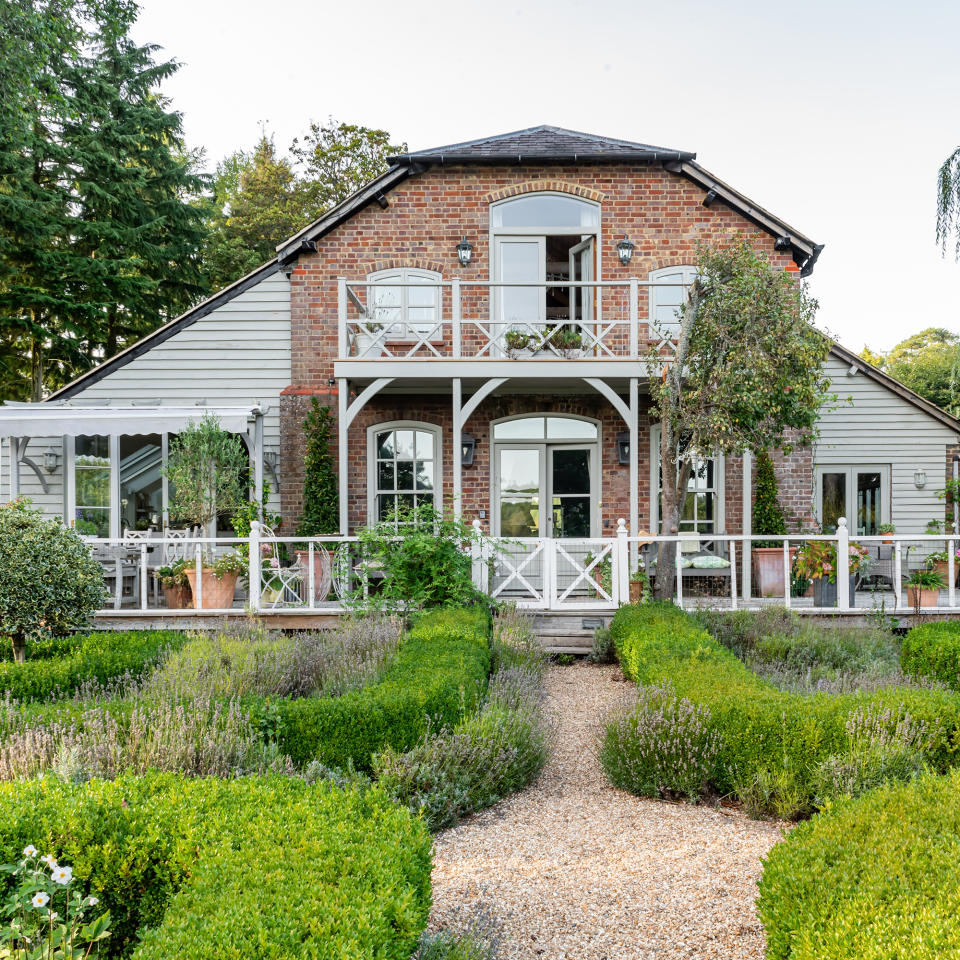     Rear of a converted Victorian building with timber clad side extensions, verandah and timber balcony. 