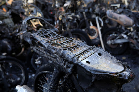 Burned motorcycles are seen following a blast at the Pentecost Church Central Surabaya (GPPS), in Surabaya, Indonesia May 13, 2018. REUTERS/Beawiharta