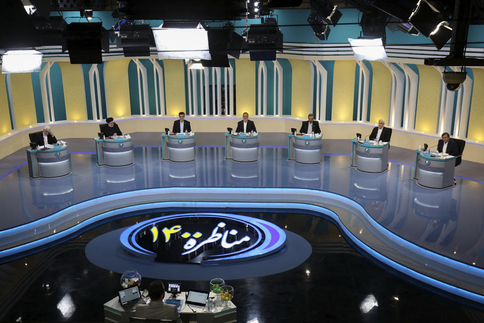 In this photo made available by the government-affiliated Young Journalists Club, presidential candidates, from left, Saeed Jalili, Ebrahim Raisi, Amir Hossein Ghazizadeh Hashemi, Alireza Zakani, Mohsen Rezaei, Mohsen Mehralizadeh, and Abdolnasser Hemmati, participate in a televised debate in a state-run television studio, in Tehran, Iran, on Saturday, June 5, 2021. Elections are scheduled for June 18. (Morteza Fakhri Nezhad/YJC via AP)
