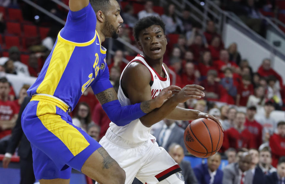 North Carolina State's Markell Johnson (11) drives past Pittsburgh's Terrell Brown (21) during the first half of an NCAA college basketball game at PNC Arena in Raleigh, N.C., Saturday, Feb. 29, 2020. (Ethan Hyman/The News & Observer via AP)