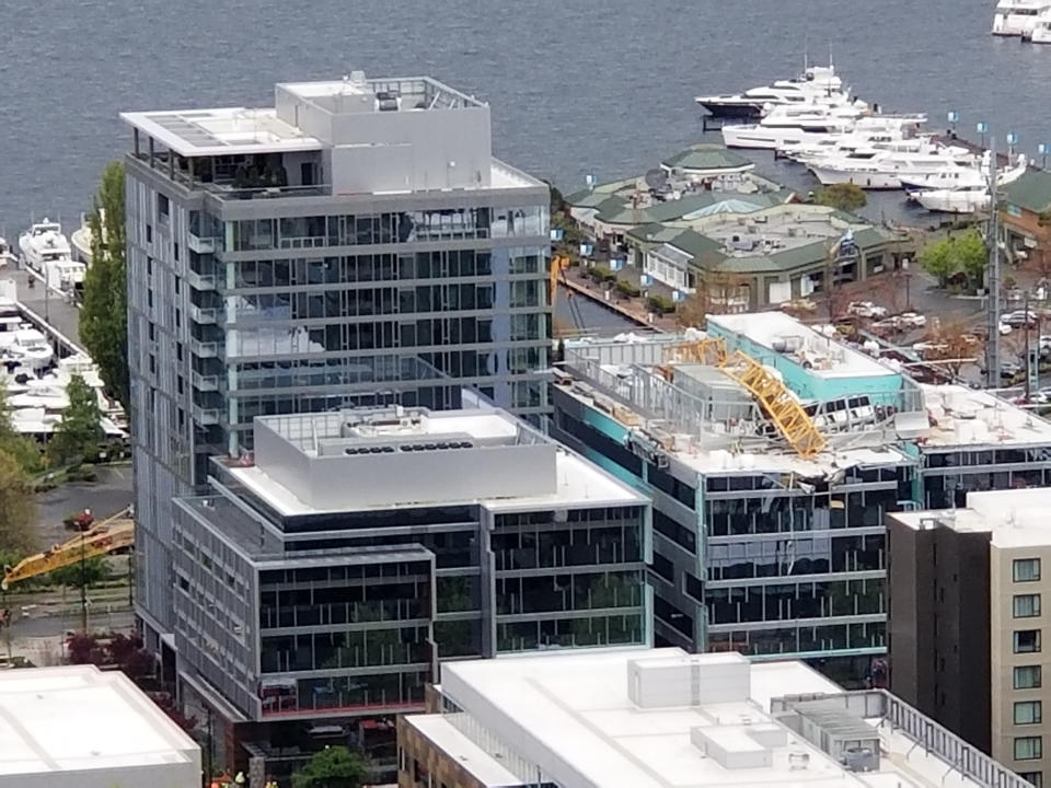 A construction crane collapsed on Mercer Street near Interstate 5 in downtown Seattle. The Seattle Times tweeted that several vehicles and a building were damaged. (Chelsea Oughton via AP)