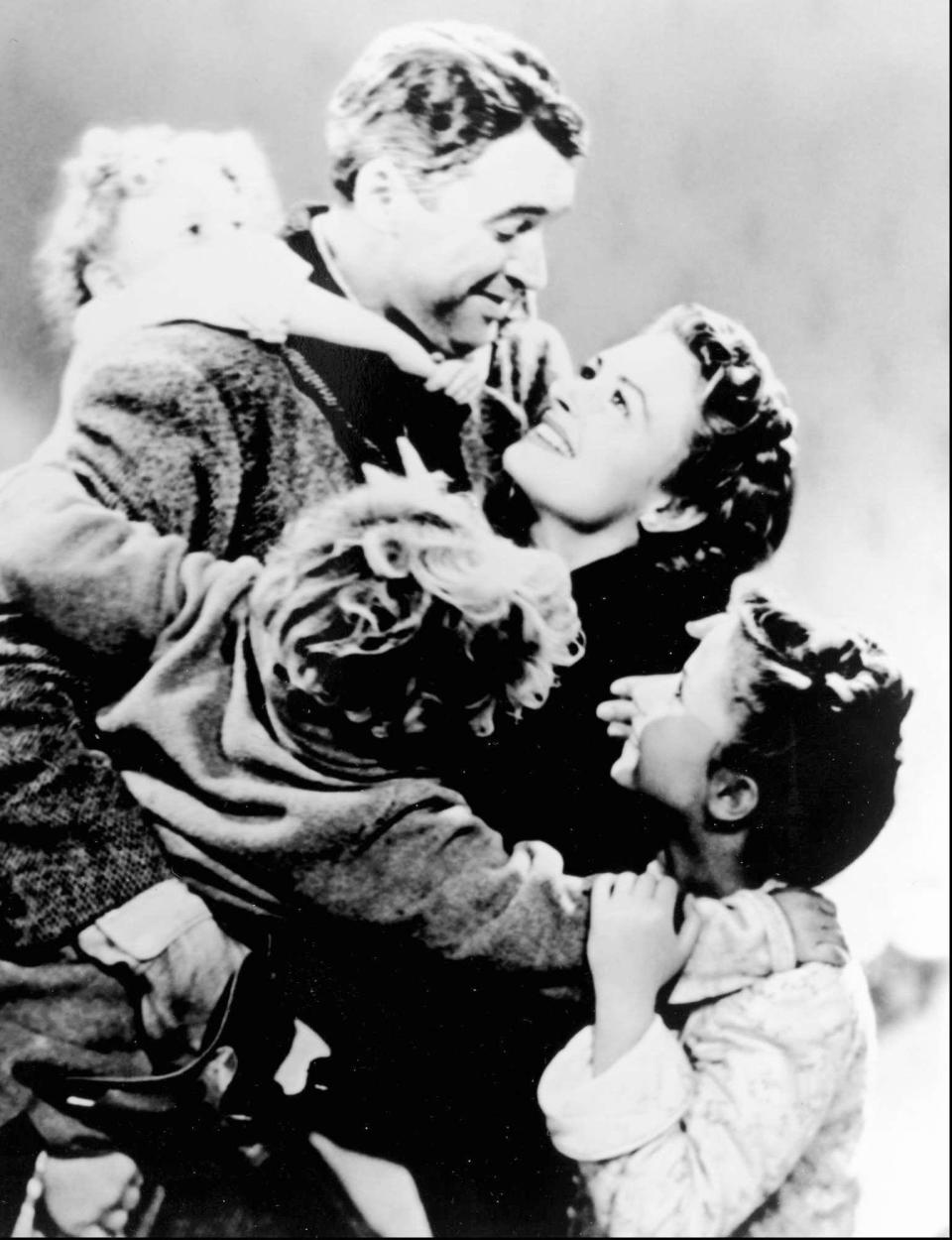 Jimmy Stewart, as George Bailey, is lovingly mauled by the rest of the Baily family in "It's a Wonderful Life.''