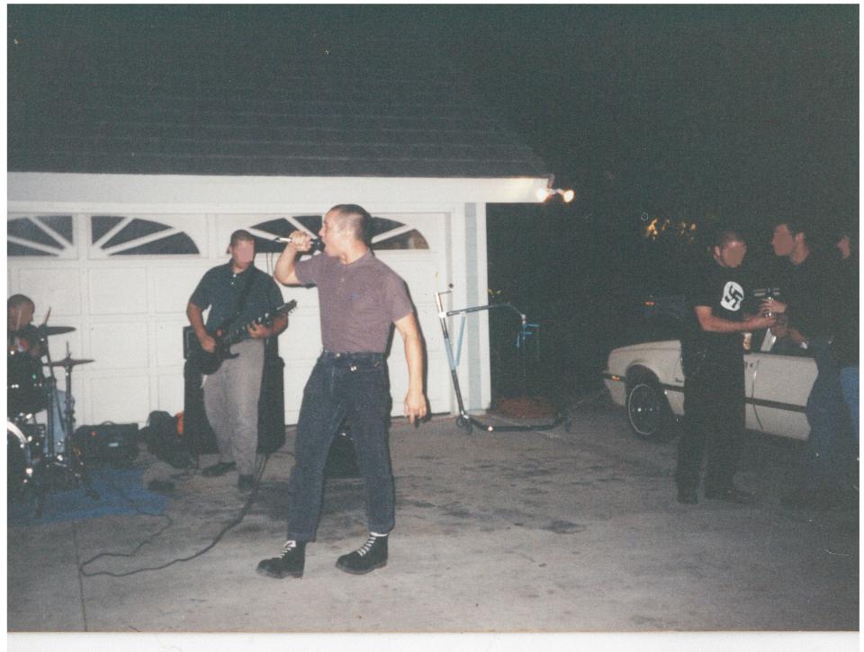 Chuck Leek performs with Battle Axe, which he calls a “white power-skinhead band,” in a driveway. (Photo: Chuck Leek)