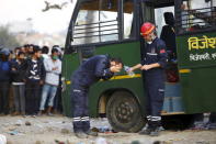 A GAE Search and Rescue team member washes his face during the rescue operation to rescue live victims trapped inside a collapsed hotel after an earthquake in Kathmandu, Nepal April 27, 2015. REUTERS/Navesh Chitrakar