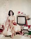 <p>The actress is the picture of Christmas in this 1955 advert, in which she poses next to a modern Christmas tree amongst dozens of presents. </p>