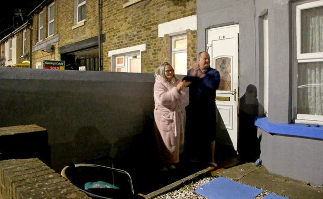 A couple outside their house in Dover, Kent, join in applause to salute local heroes during the nationwide Clap for Heroes event to recognise and support NHS workers and carers fighting the coronavirus pandemic in the latest lockdown