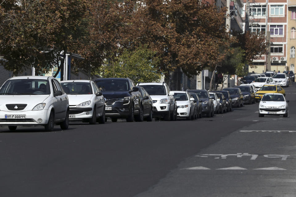 Vehicles queue to enter a gas station in Tehran, Iran, Friday, Nov. 15, 2019. Authorities have imposed rationing and increased the prices of fuel. The decision came following months of speculations about possible rationing after the U.S. in 2018 reimposed sanctions that sent Iran's economy into free-fall following Washington withdrawal from 2015 nuclear deal between Iran and world powers. (AP Photo/Vahid Salemi)