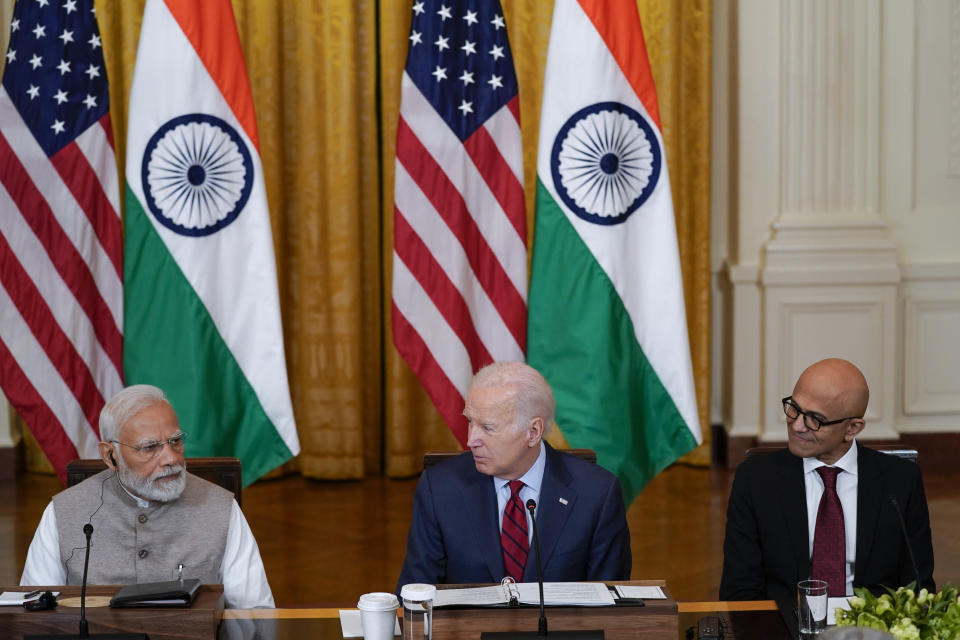 President Joe Biden speaks during a meeting with India's Prime Minister Narendra Modi and American and Indian business leaders in the East Room of the White House, Friday, June 23, 2023, in Washington. Satya Nadella, CEO of Microsoft, listens at right. (AP Photo/Evan Vucci)