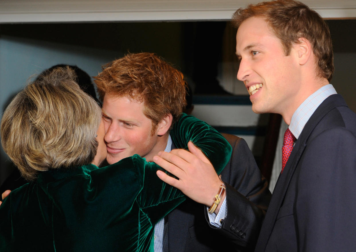 LONDON - JANUARY 08:  Prince Harry (C) embraces Claire Van Strawbenzee (L) as his brother Prince William (R) looks on at a reception to mark the formal launch of the Henry Van Straubenzee Memorial Fund on January 8, 2008 in London. William and his brother, Prince Harry, were attending the reception as joint patrons to mark the formal launch of the charity, which was set up following the death of Henry Van Straubenzee, a friend of the Princes, and aims to support schools in Uganda where Henry was working.  (Photo by Toby Melville/WPA Pool/Getty Images)