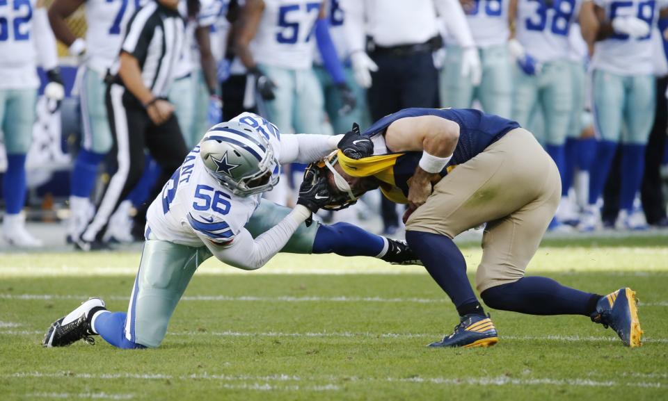 <p>Dallas Cowboys’ Justin Durant grabs the face mask of Green Bay Packers’ Aaron Rodgers during the first half of an NFL football game Sunday, Oct. 16, 2016, in Green Bay, Wis. (AP Photo/Mike Roemer) </p>