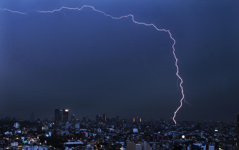 A bolt of lightning strikes during an early morning storm in Mexico City, Monday, June 22, 2020. (AP Photo/Marco Ugarte)