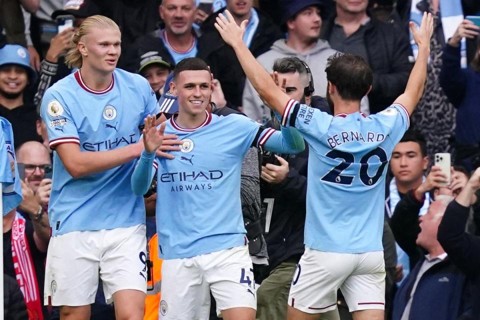 Erling Haaland, left, and Phil Foden, centre, scored hat-tricks for Manchester City (Martin Rickett/PA) (PA Wire)