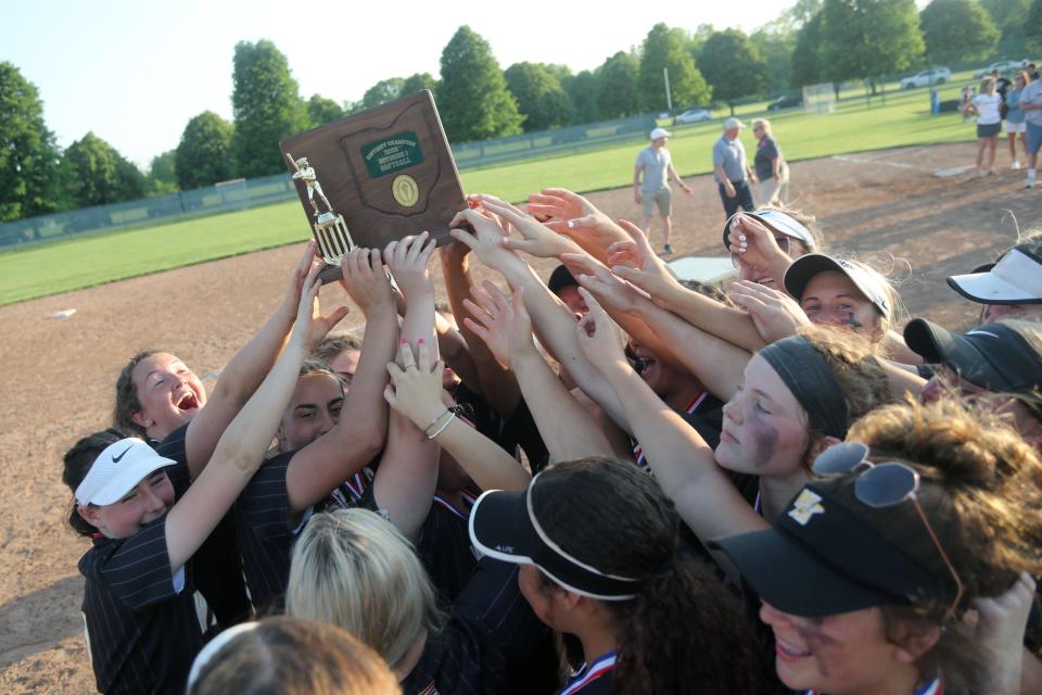 Watkins Memorial players hoist up the district championship trophy as they celebrate a 9-1 win over Westerville Central in a Division I district final game May 20 at Pickerington High School Central.