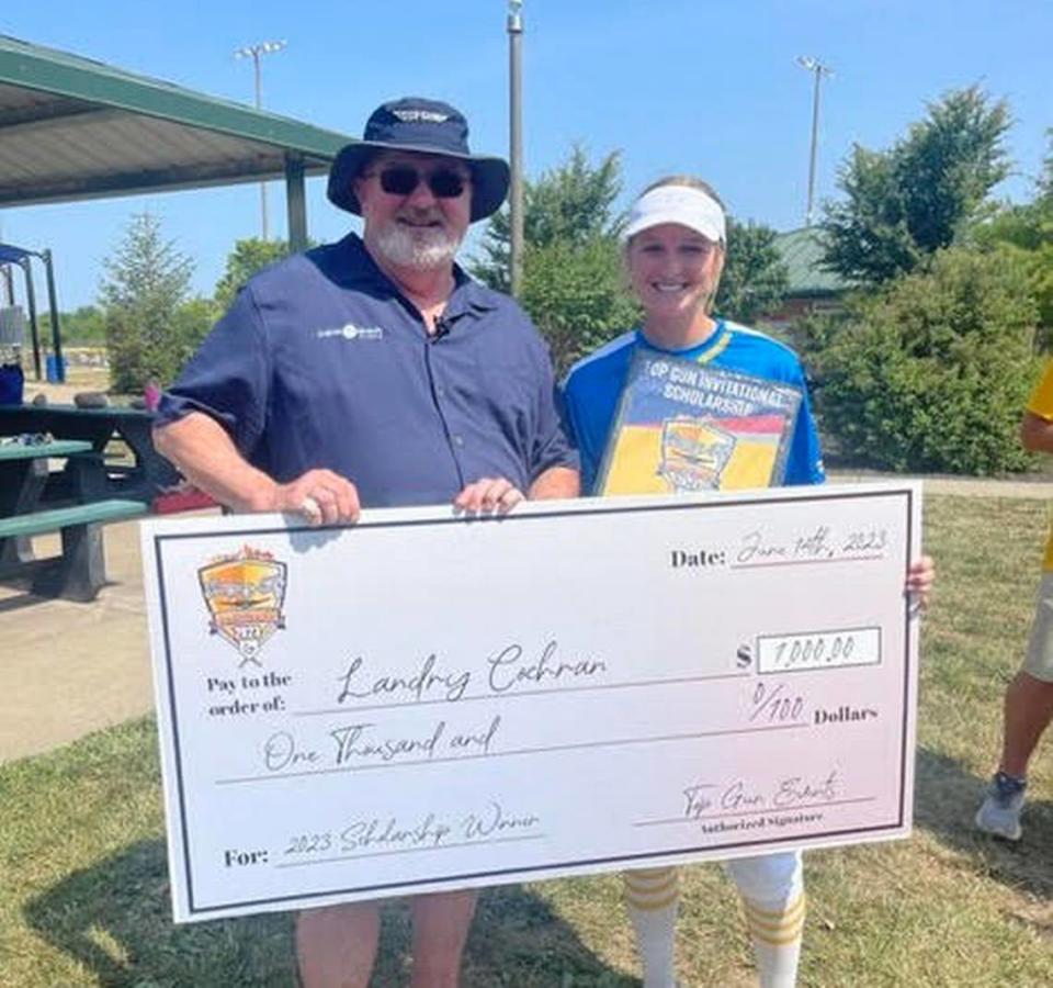 Scholarship winner Landry Cochran of the Missouri Chiefs stands with Top Gun Invitational founder Robb Behymer during the 2023 event in KC.