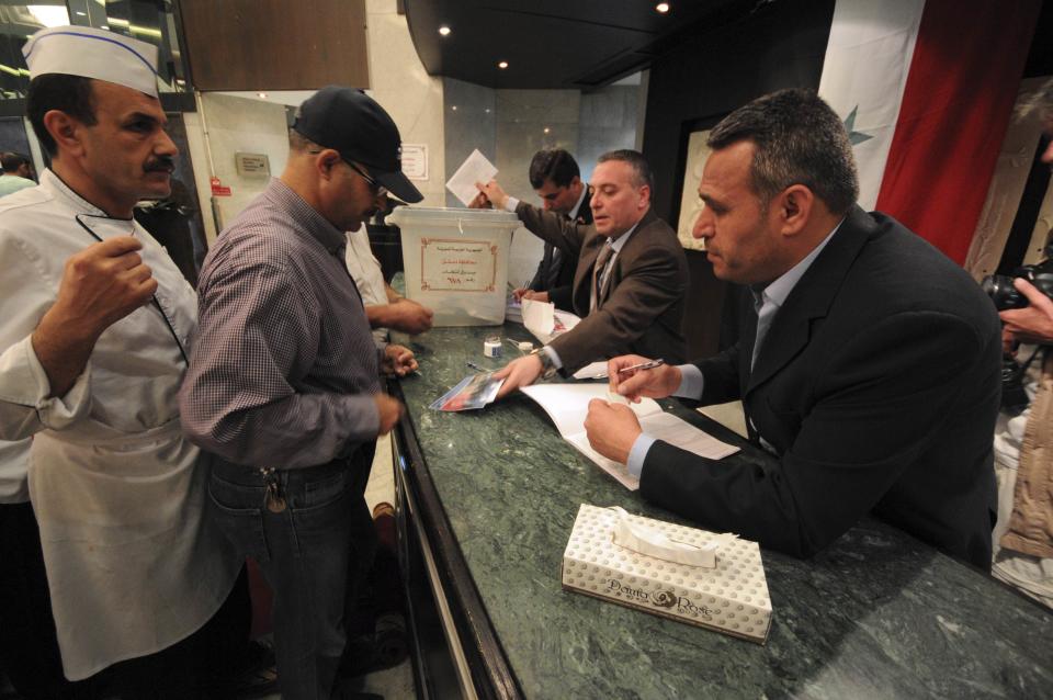 Men cast their votes at Dama Rose hotel during the presidential election in Damascus, June 3, 2014. (REUTERS/Omar Sanadiki)
