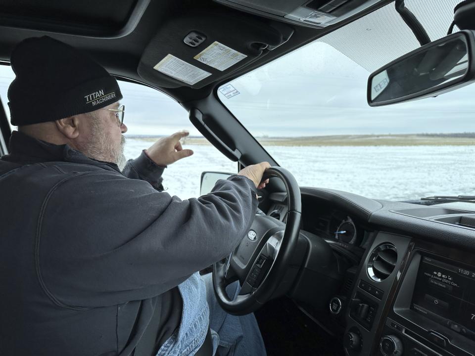 Dan McLean, shown Wednesday, March 6, 2024, points to where Summit Carbon Solutions' proposed carbon dioxide pipeline would cross his land near Menoken, N.D. The project has drawn opposition from numerous Midwestern landowners, including McLean. (AP Photo/Jack Dura)