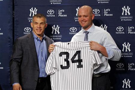 Dec 5, 2013; Bronx, NY, USA; New York Yankees manager Joe Girardi (right) and new catcher Brian McCann during press conference at Yankees Stadium. Noah K. Murray-USA TODAY Sports