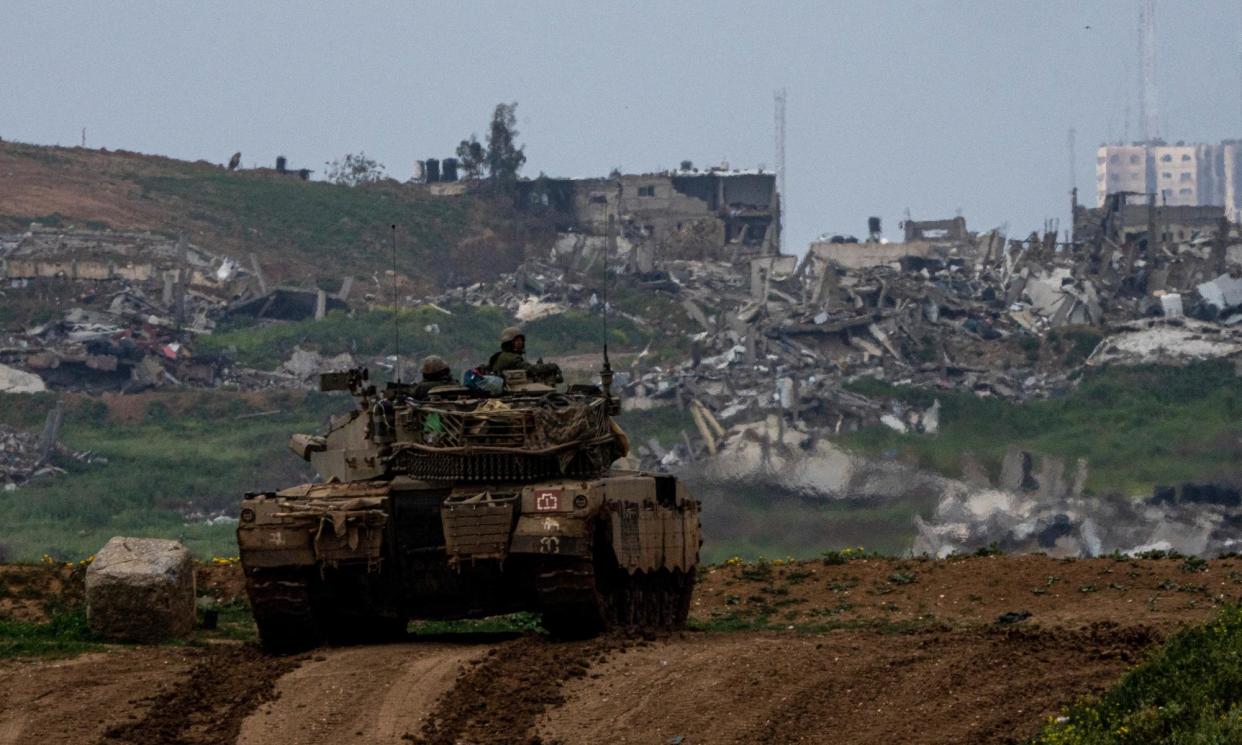 <span>Israeli soldiers on the border with the Gaza Strip, as seen from southern Israel.</span><span>Photograph: Ariel Schalit/AP</span>