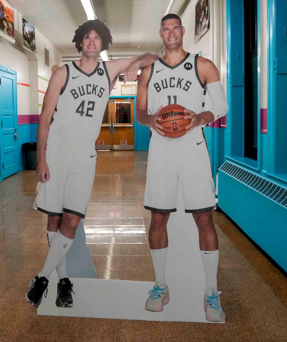 The Lopez brothers, Robin and Brook, of the Milwaukee Bucks host a Scholastic Book Fair Wednesday at Auer Avenue Elementary School, allowing each student to select five new books.