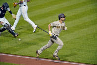 San Diego Padres starting pitcher Yu Darvish carries his bat as he runs to first base as Pittsburgh Pirates catcher Jacob Stallings, left, fields the ball to make the putout on him at first base to end the top of the sixth inning during a baseball game in Pittsburgh, Monday, April 12, 2021. (AP Photo/Gene J. Puskar)