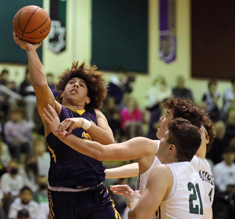 Tallmadge's Collin Dixon, left, looks for a layup against during a 79-61 win over Aurora on Friday night. [Jeff Lange/Beacon Journal]