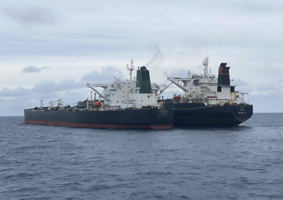 In this photo released by Indonesian Maritime Security Agency (BAKAMLA), Iranian-flagged MT Horse, left, and Panamanian-flagged MT Frea tankers are seen anchored together in Pontianak waters off Borneo island, Indonesia, Sunday, Jan. 24, 2021. Indonesian authorities said that they seized the two vessels suspected of carrying out the illegal transfer of oil in their country's waters. (Indonesian Maritime Security Agency via AP)