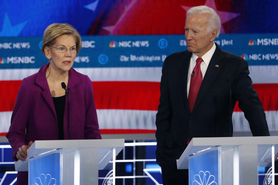 Democratic presidential candidate Sen. Elizabeth Warren, D-Mass., speaks as Democratic presidential candidate former Vice President Joe Biden listens during a Democratic presidential primary debate, Wednesday, Nov. 20, 2019, in Atlanta. (AP Photo/John Bazemore)