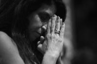 <p>A delegate bows her head during the invocation at the RNC Convention in Cleveland, OH. on July 21, 2016. (Photo: Khue Bui for Yahoo News)</p>