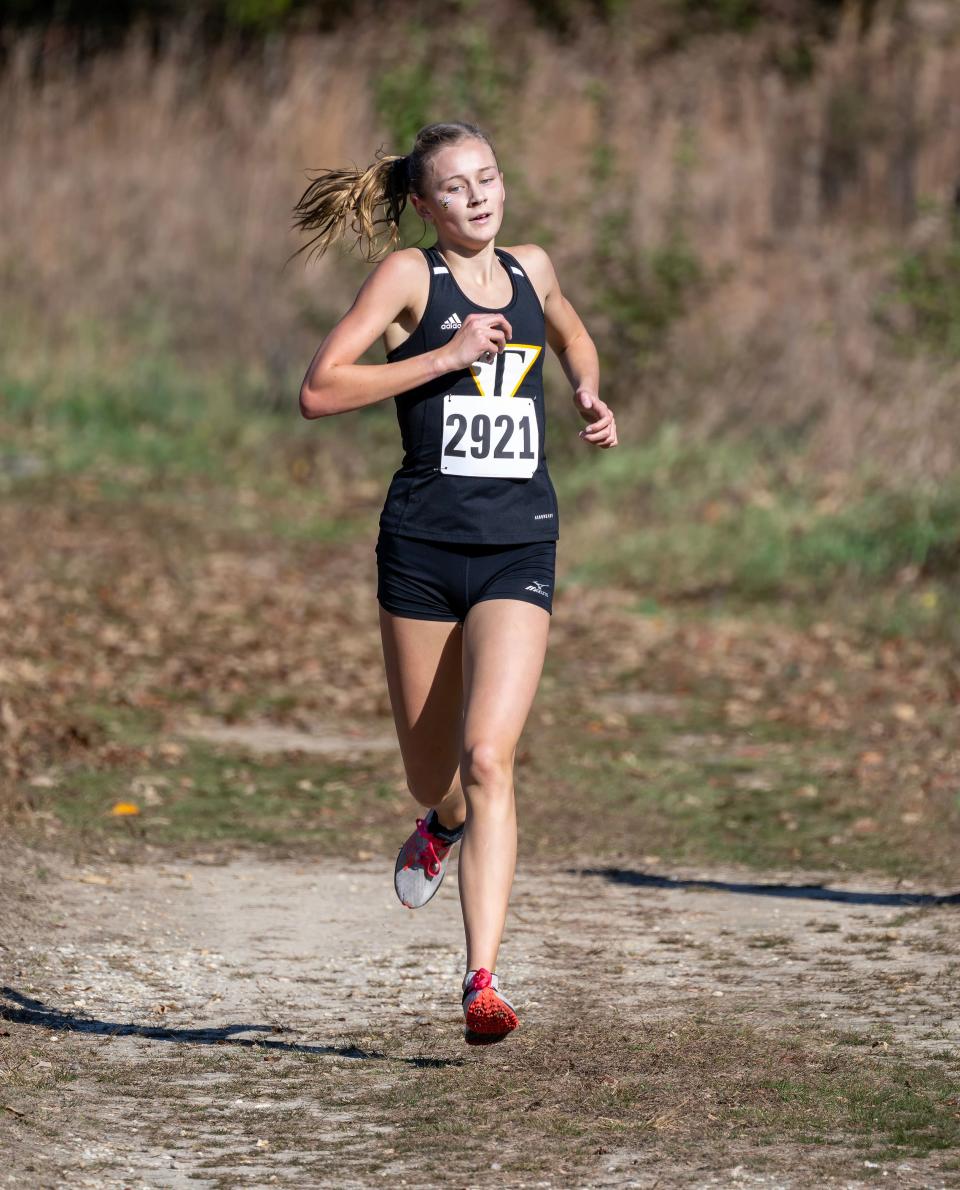 Tatnall’s Katie Payne heads for a second place finish as she runs in the DIAA 2022 Cross Country Girl’s Division II Championship at Killens Pond State Park in Felton, Del.