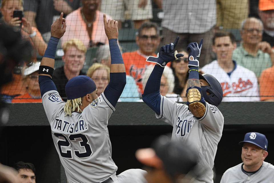 San Diego Padres' Manny Machado, right, celebrates his home run with Fernando Tatis Jr. (23) during the third inning of a baseball game against the Baltimore Orioles, Tuesday, June 25, 2019, in Baltimore. (AP Photo/Nick Wass)